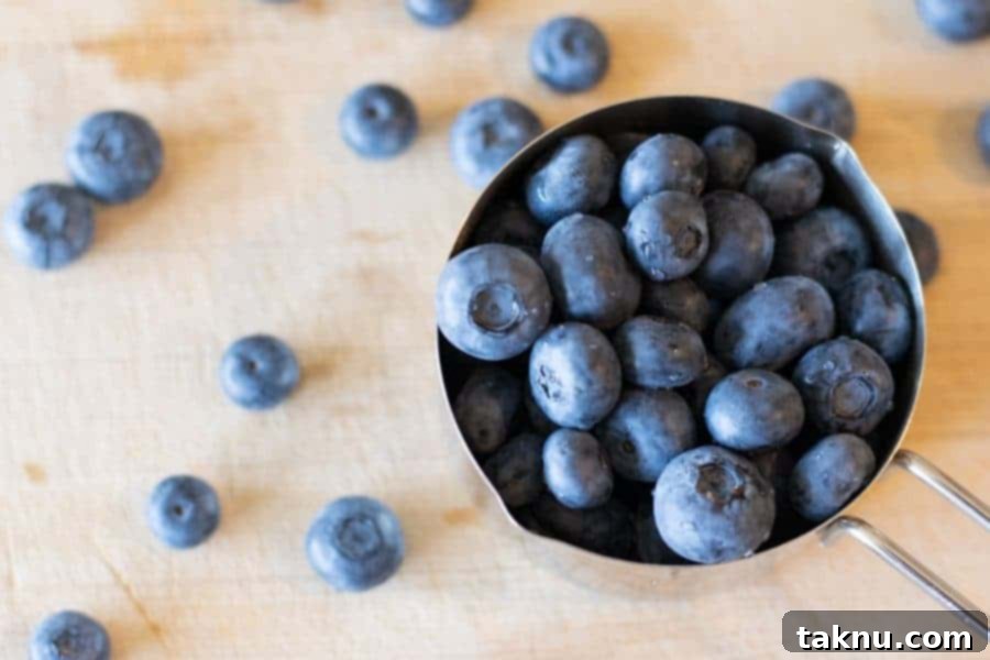 Blueberry Bourbon Marinated Venison Jerky 7 Fresh, vibrant blueberries gathered in a measuring cup, ready to be incorporated into the marinade.