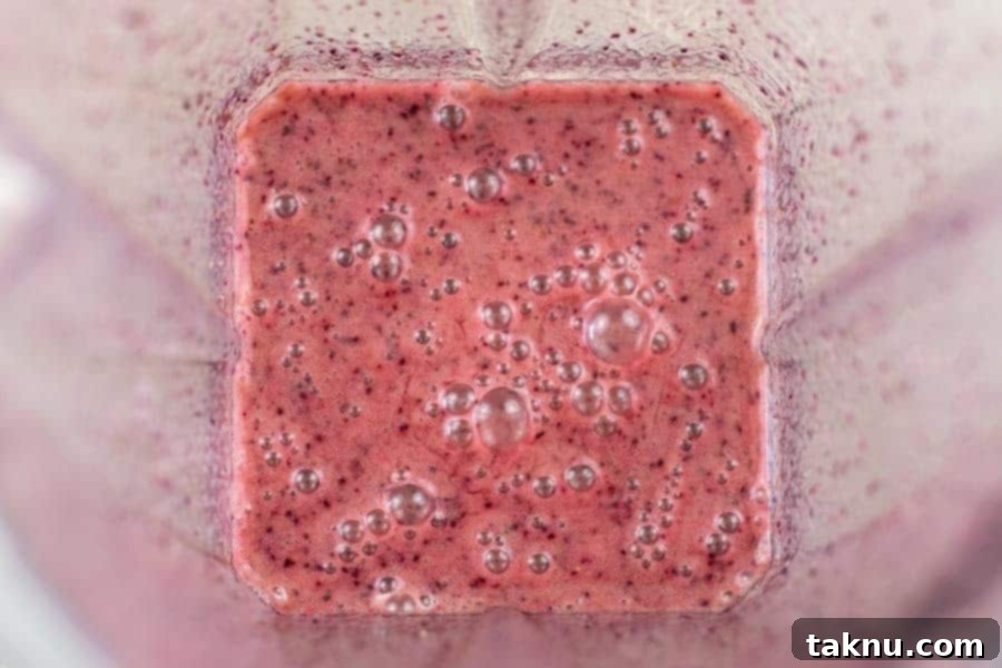 Blueberry Bourbon Marinated Venison Jerky 8 The blueberry bourbon jerky marinade, perfectly blended and swirling in a blender, ready to infuse flavor.