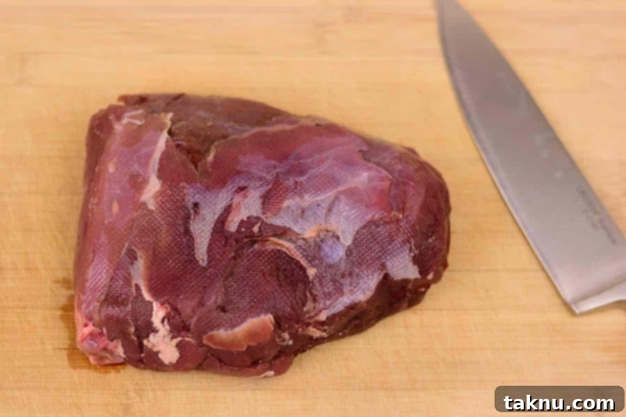 Venison Roast on cutting board with knife