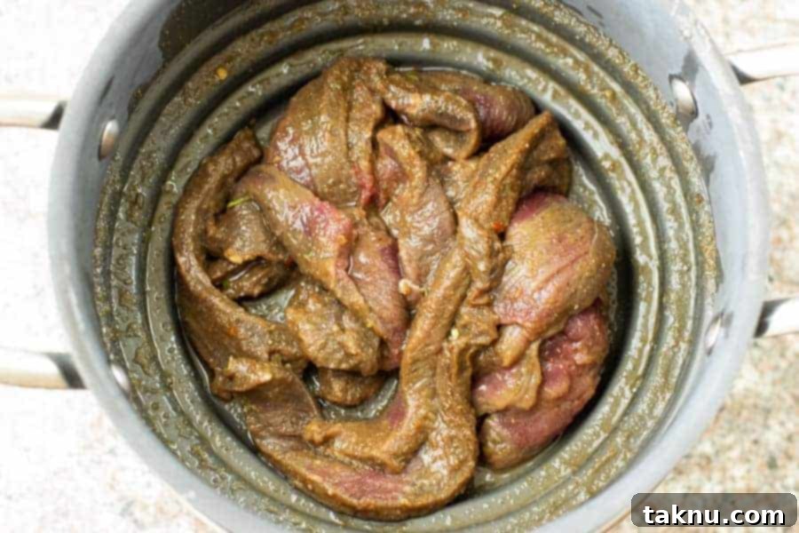 deer jerky straining of marinade in colander