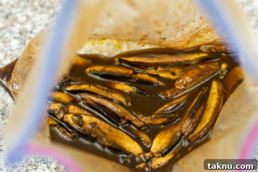 Sliced mushrooms in marinade in ziplock bag