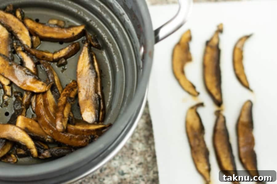 drained mushrooms in colander and sliced mushrooms on paper towel 