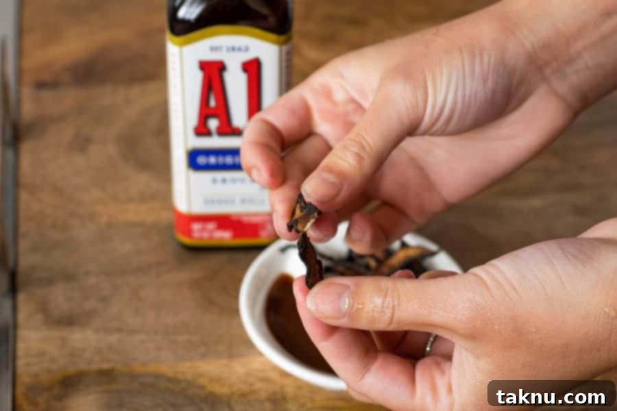 breaking a piece of mushroom jerky, A1 bottle on table