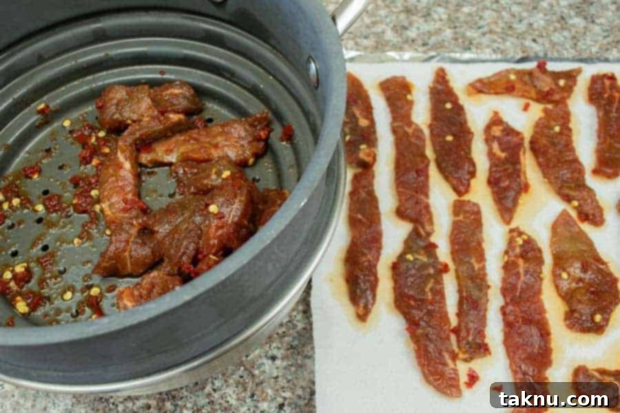 Blazing Cherry Beef Strips 11 Patting dry jerky strips on paper towels