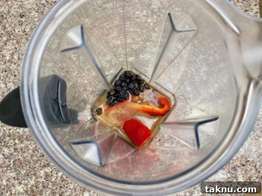Blended ingredients for the blueberry eggplant marinade in a blender cup, showcasing its smooth consistency