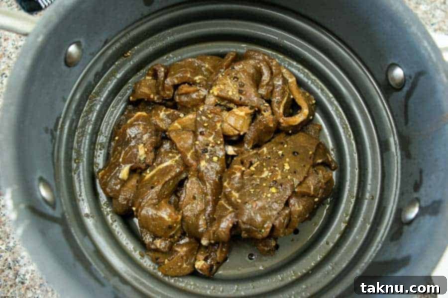 Lemon pepper jerky straining in colander