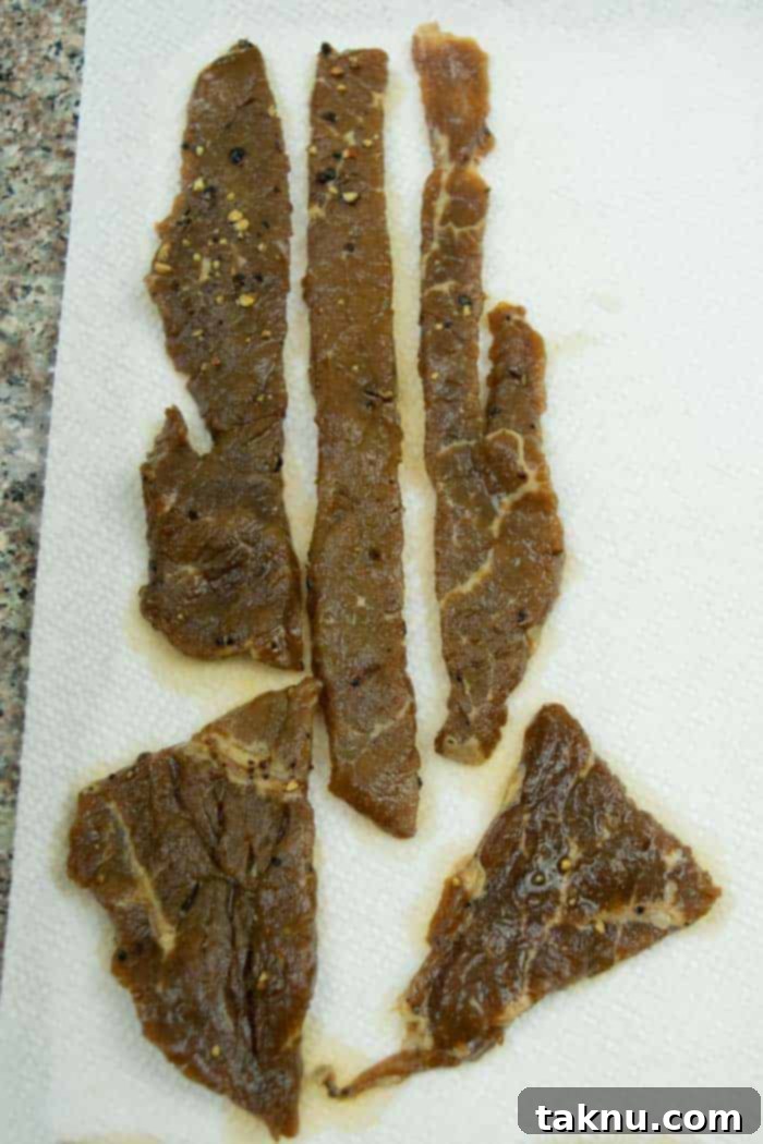 Lemon pepper jerky drying on paper towels
