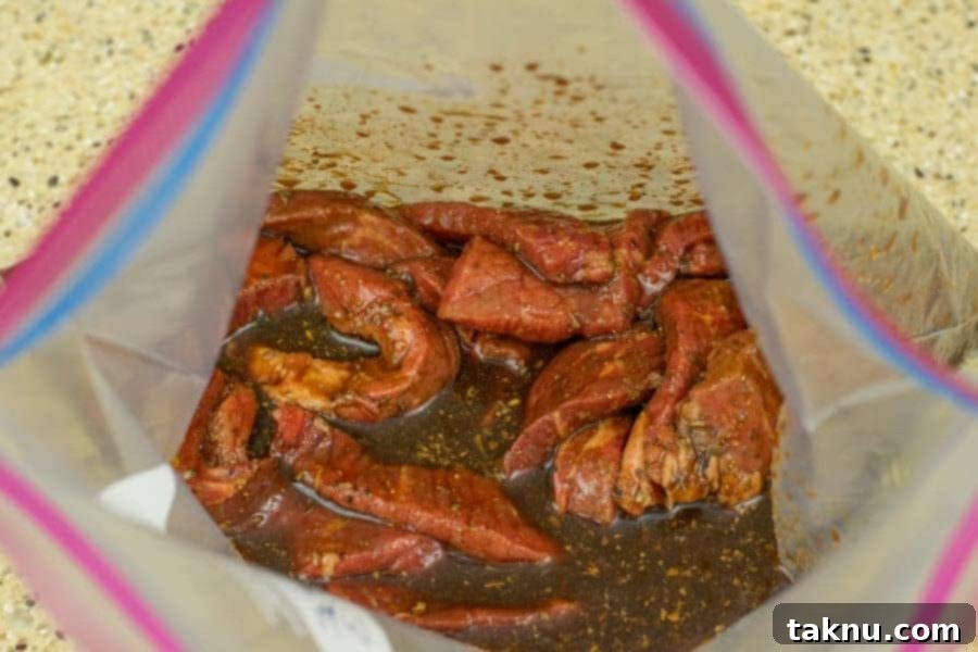 Gunslinger's Jerky 9 Beef jerky strips marinating in a ziplock bag, ensuring even flavor distribution.