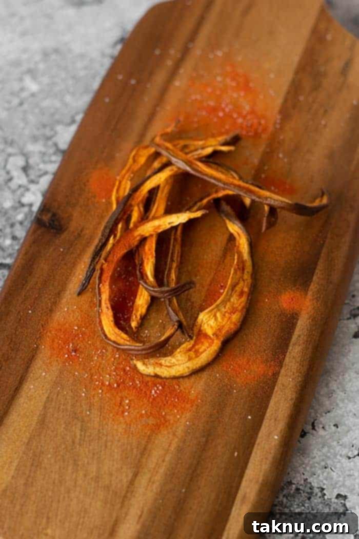 Eggplant Jerky on wooden cutting board with tomato powder