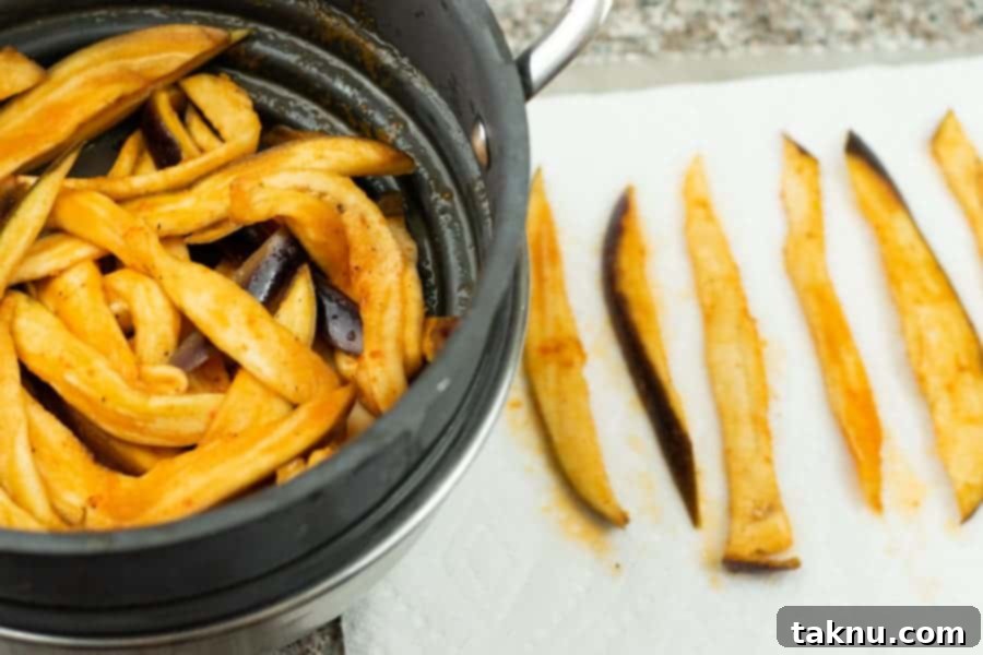 eggplant jerky in colander and paper towel