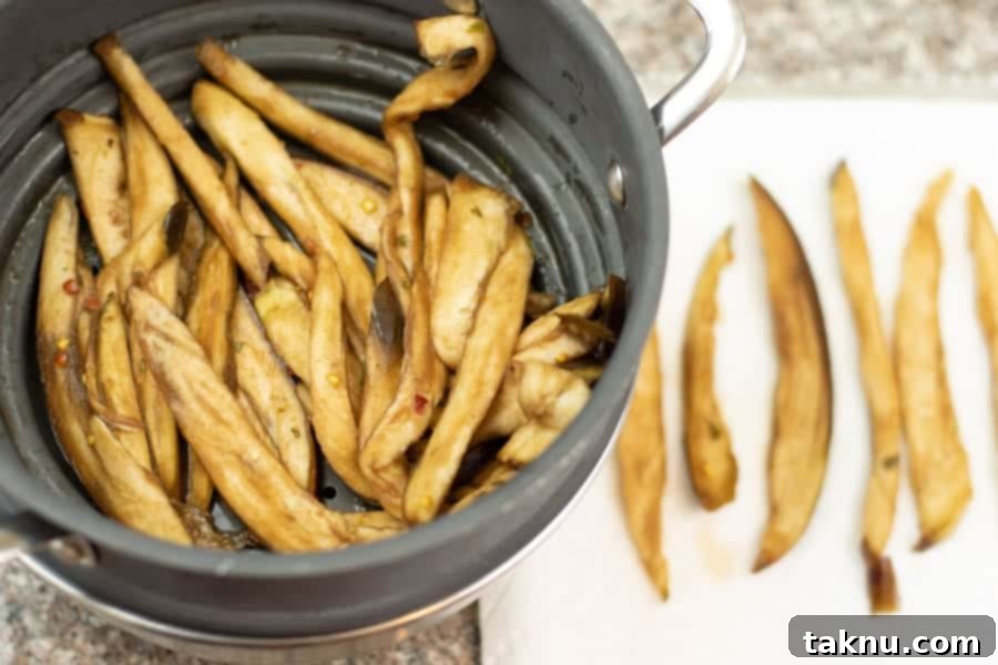 Sun-Kissed Eggplant Bites 8 Eggplant jerky in colander and on paper towel
