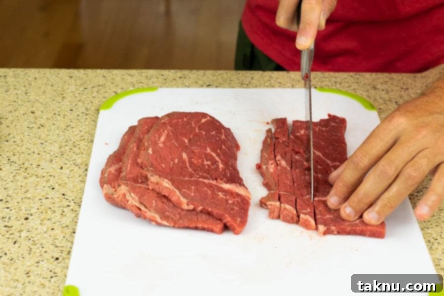 Blaze Beef Jerky 6 Slicing a bottom round roast for jerky, illustrating ideal thickness and consistency