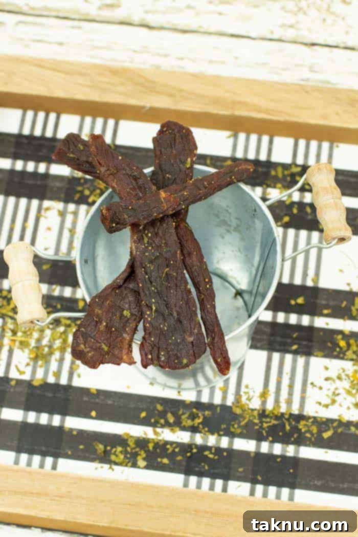 Beef jerky on bowl with checkered tray underneath