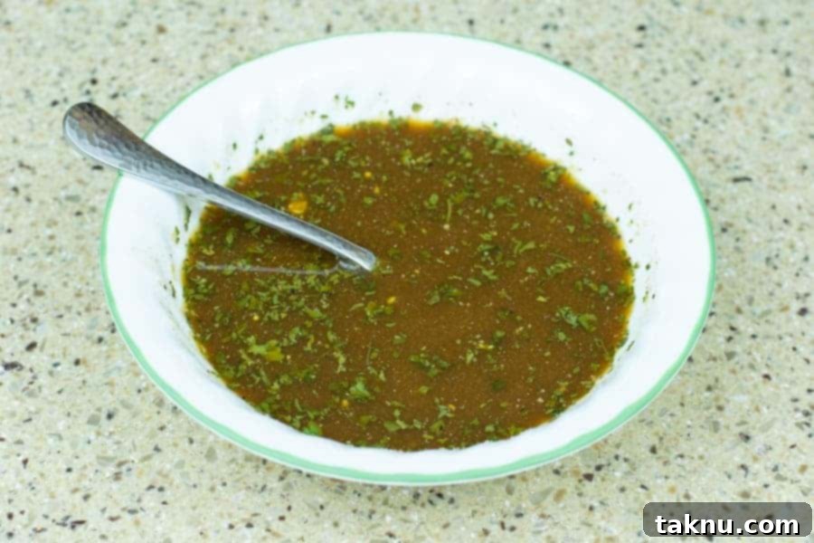 Jerky marinade in bowl with spoon