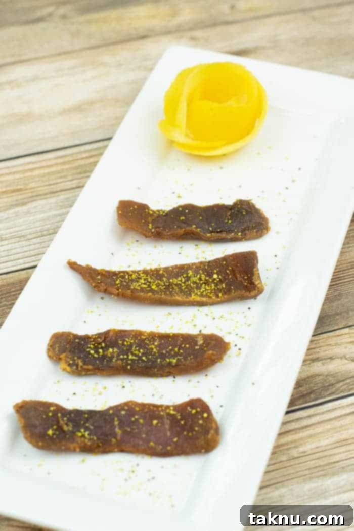 Zesty Inferno Tuna Strips 2 Spicy lemon tuna jerky on a platter with fresh lemon slices