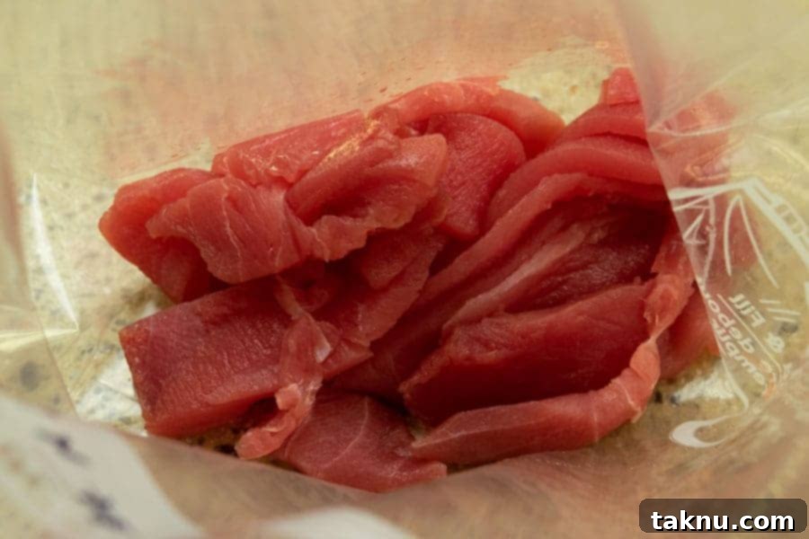 Zesty Inferno Tuna Strips 4 Sliced tuna strips neatly placed in a resealable bag, ready for marination