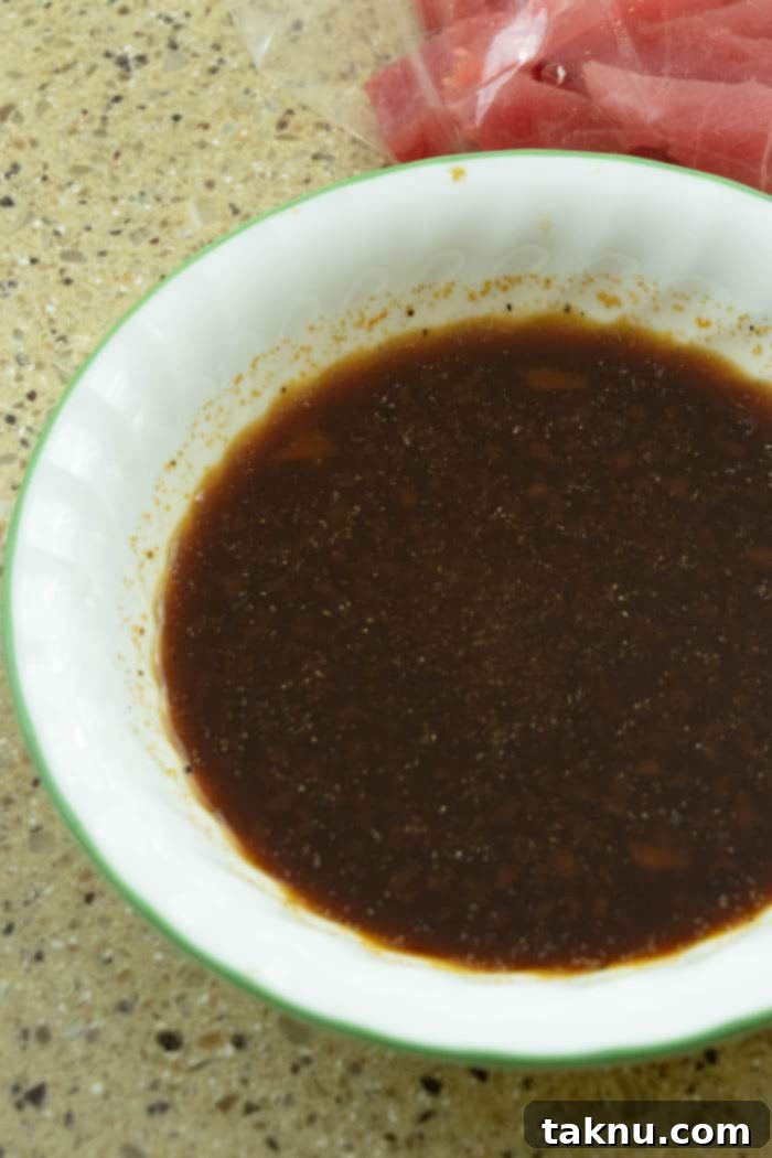 Zesty Inferno Tuna Strips 5 Bowl containing the mixed marinade ingredients for fish jerky