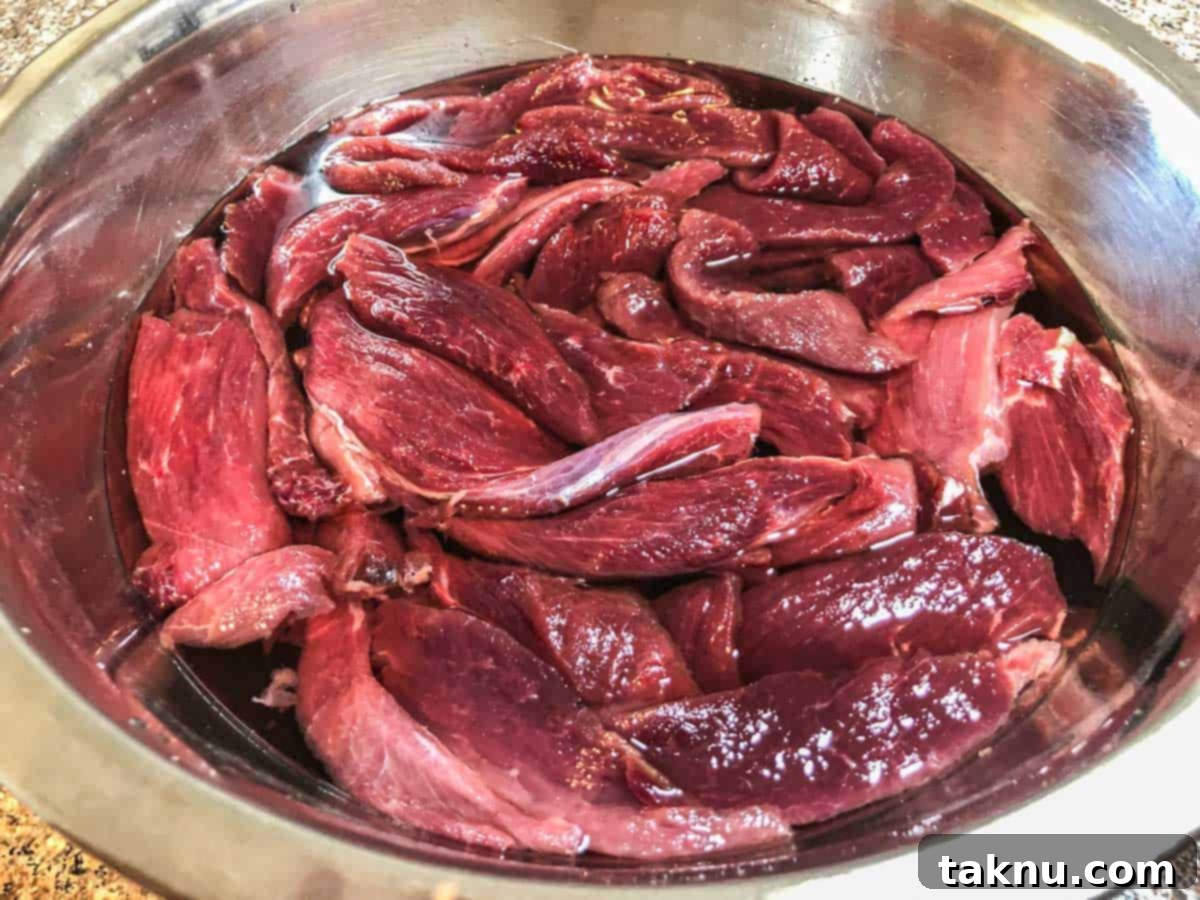Sesame Glazed Venison Strips 3 Venison soaking in salt water bowl