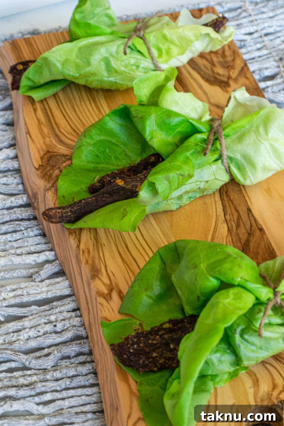 Bold Asian Venison Jerky 2 Deer jerky in lettuce wrap on cutting board