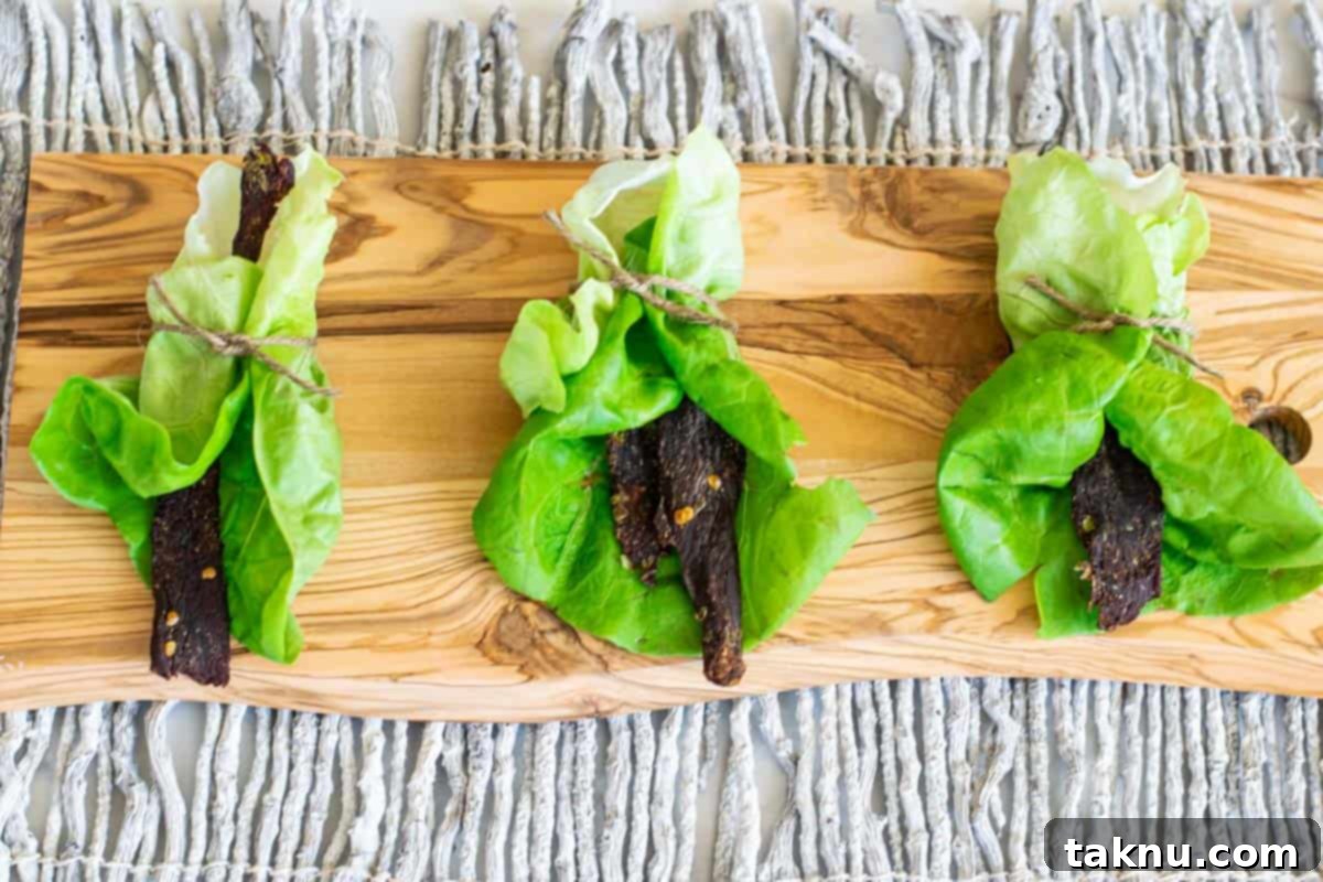 Bold Asian Venison Jerky 8 venison jerky in lettuce wraps on cutting board
