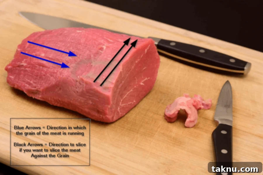Bold Peppered Beef Jerky 3 Meat on cutting board with arrows showing direction of the grain of meat