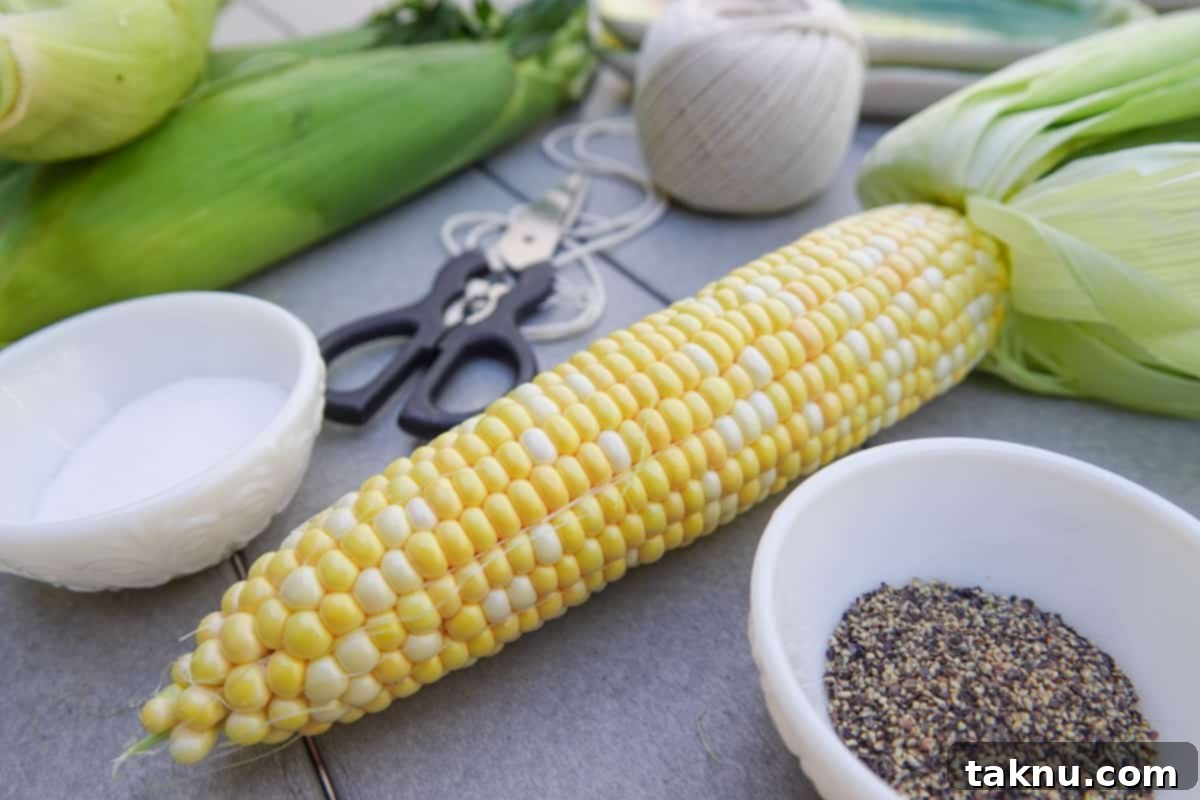 Ear of corn on table with salt and pepper, perfectly smoked and seasoned