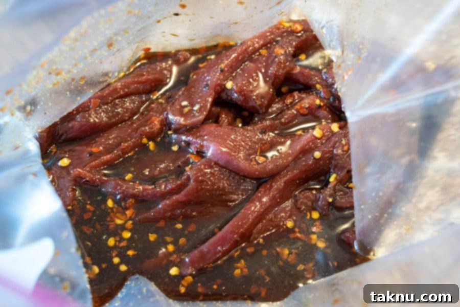 Homemade Dehydrator Beef Jerky 8 Beef Jerky strips marinating in a ziplock bag inside a refrigerator