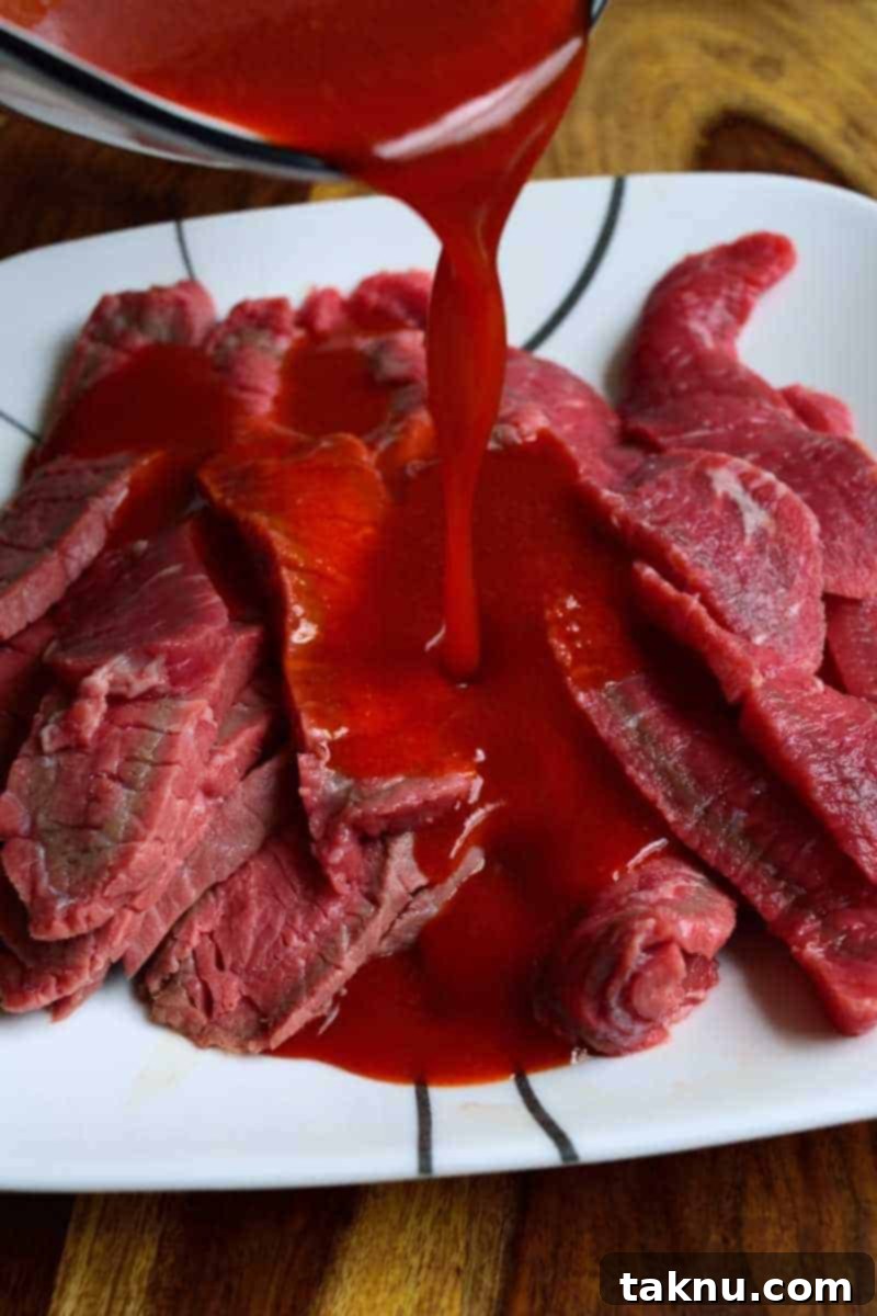 Sweet Heat Sriracha Jerky Poured over Strips