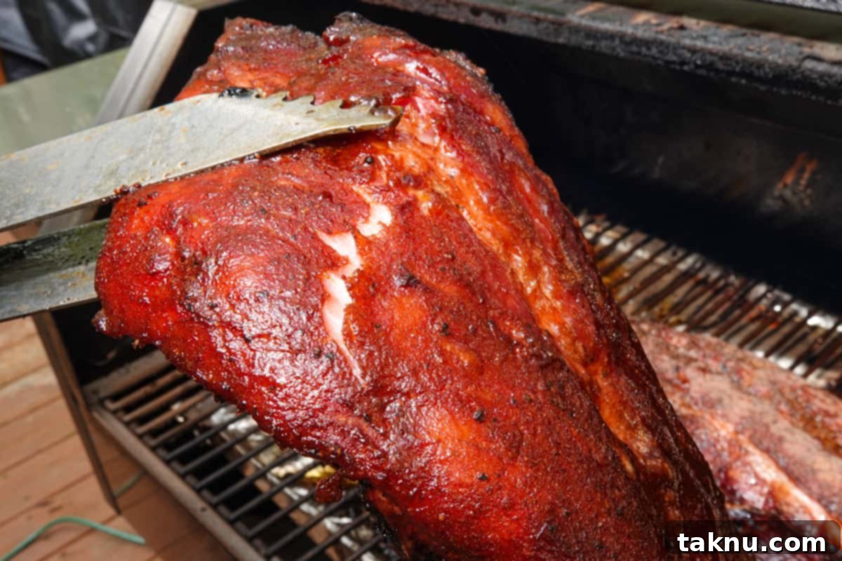 Smoked ribs being bent to show they are finished cooking