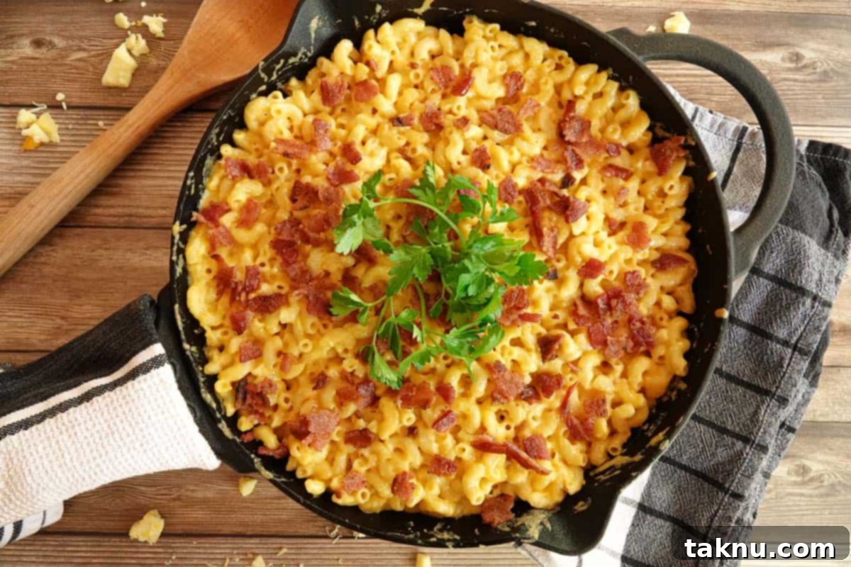 Ultimate Smoked Mac and Cheese 8 smoked mac and cheese in cast iron with spoon on side