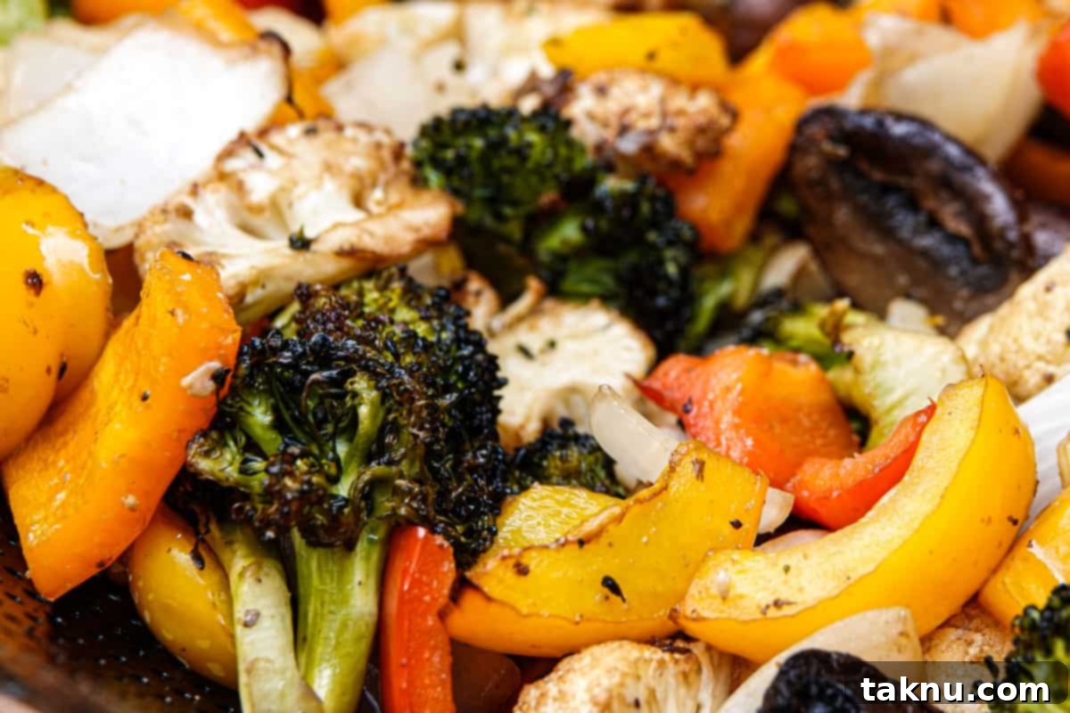 A vibrant mix of perfectly cooked smoked vegetables in a bowl, showcasing their delicious char and appealing textures.