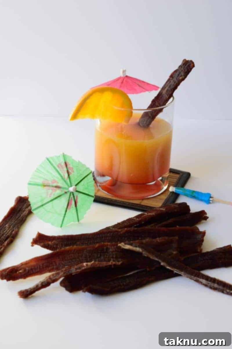 Tropical Mai Tai Beef Jerky 2 Flavorful Mai Tai Beef Jerky strips ready to eat, evoking tropical memories