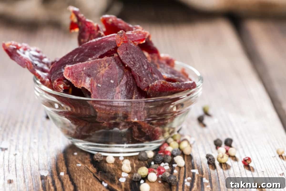 Smoked beef jerky in bowl with seasonings at base