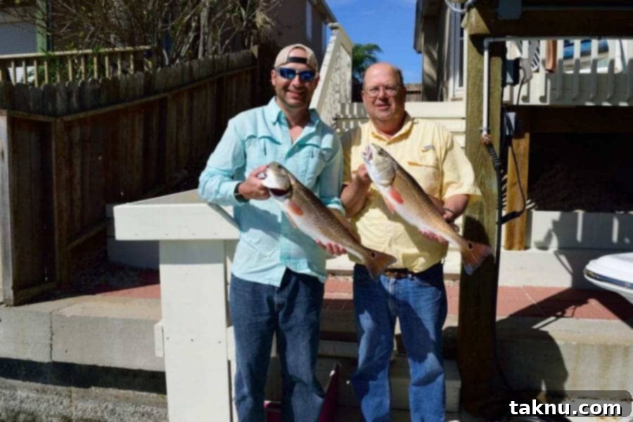 My Dad & I Holding Redfish caught during our fishing trip