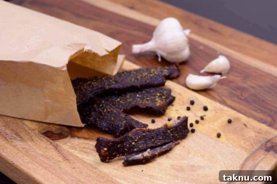 Crafting Smoked Beef Jerky 16 Finished garlic black pepper beef jerky, showcasing its rich color and texture.