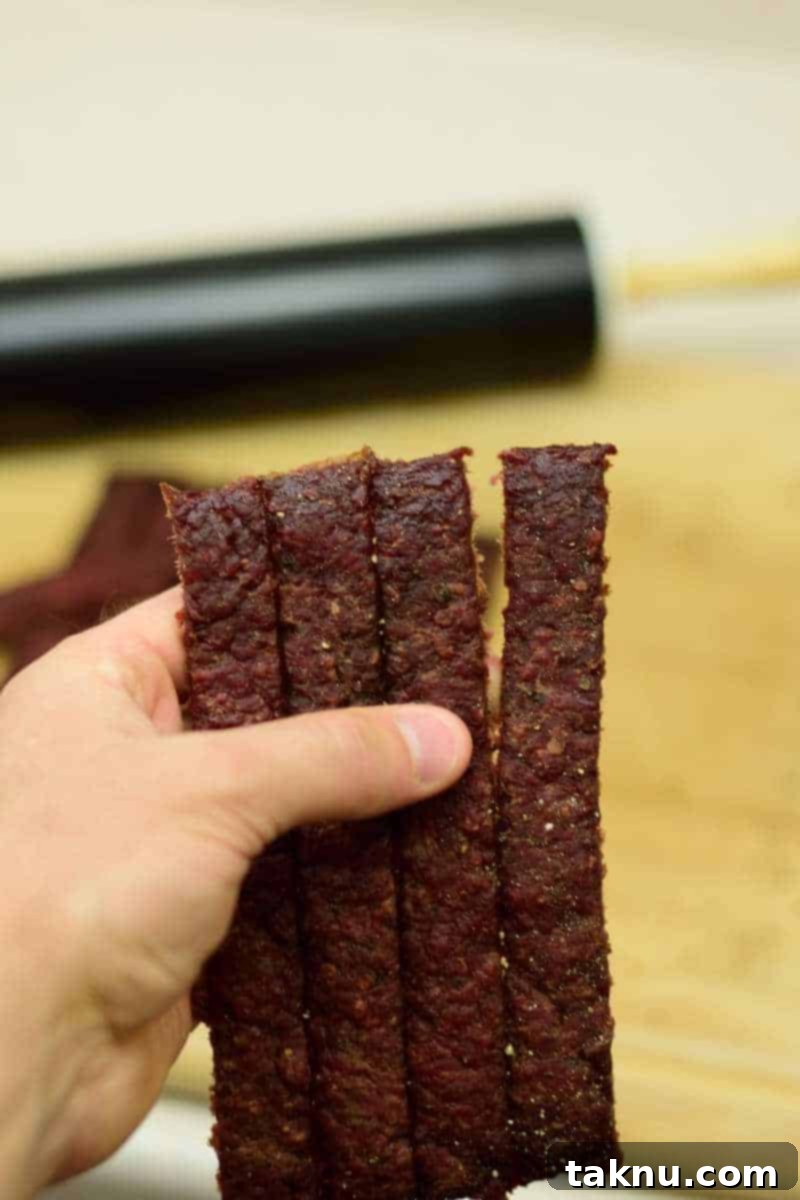 Deliciously chewy oven-baked ground beef jerky, perfect for an easy energy snack. Learn how to make homemade jerky with simple ingredients.